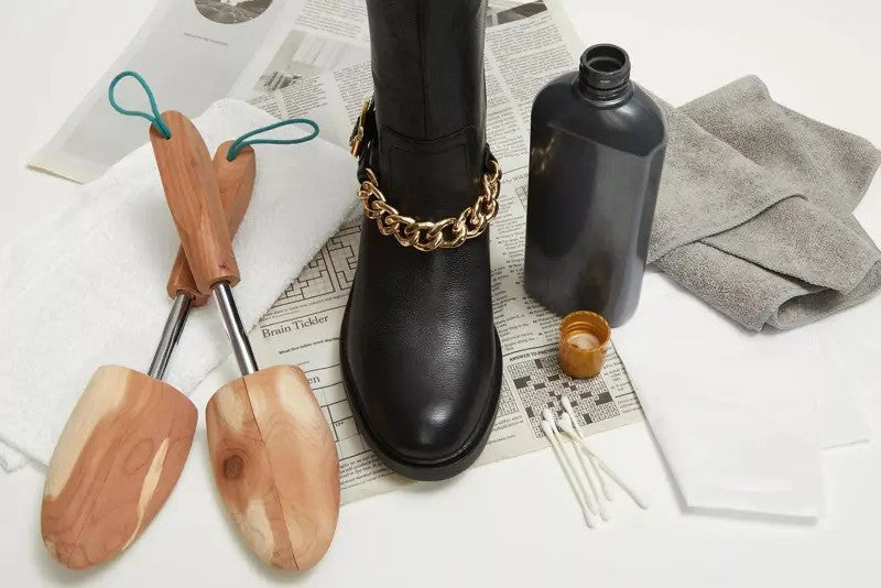 An above shot of a  pair of black pointed pump heels, featuring a grippy insole on the right shoe's interioe