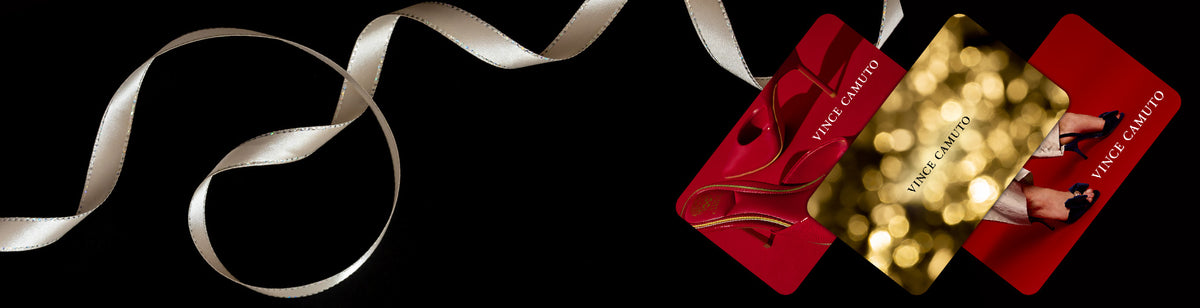 Black background with the 3 versions of the Vince Camuto E-Gift Cards on display with a gold holiday ribbon wrapping throughout