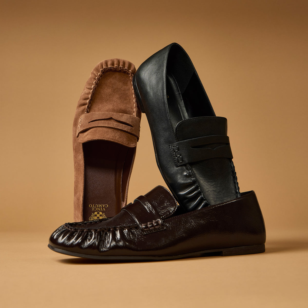 3 loafers stacked agaist a tan background