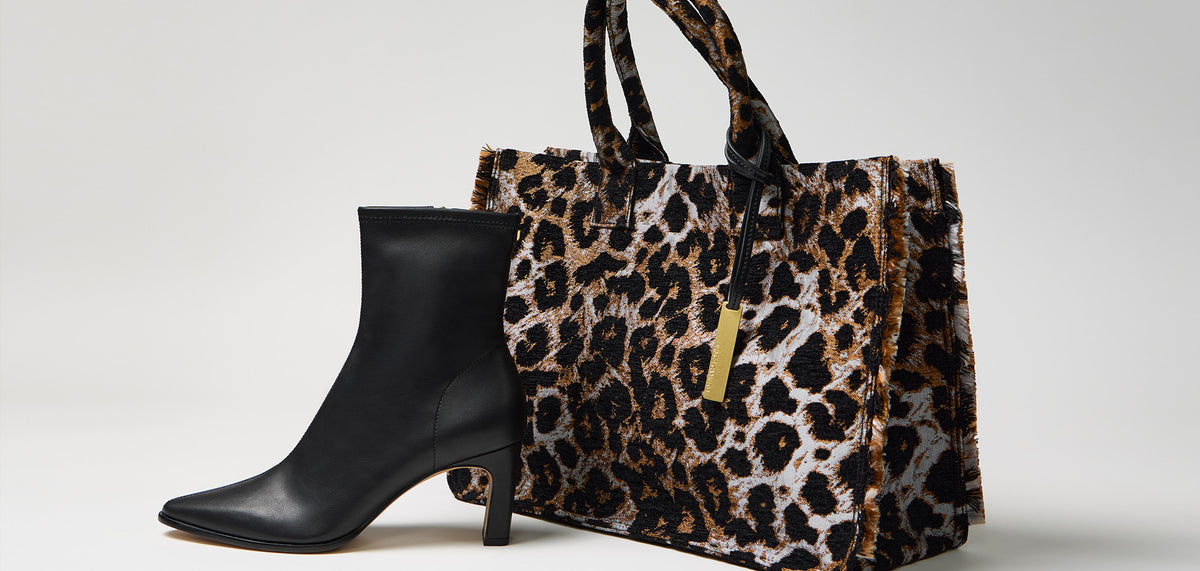 black square toed bootie and an animal print tote bag against a white background 
