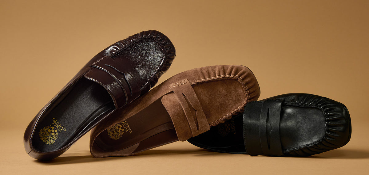 3 brown and black loafers styled on their side against a tan background 