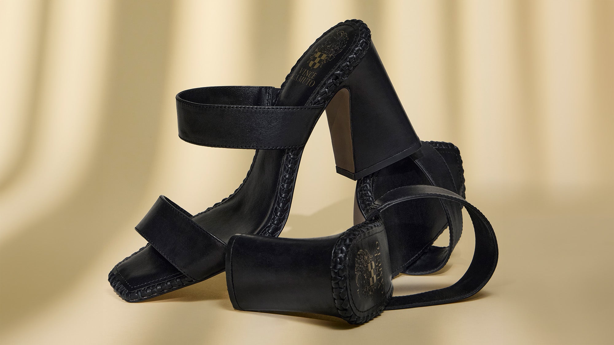 black heeled sandals on shadowy background