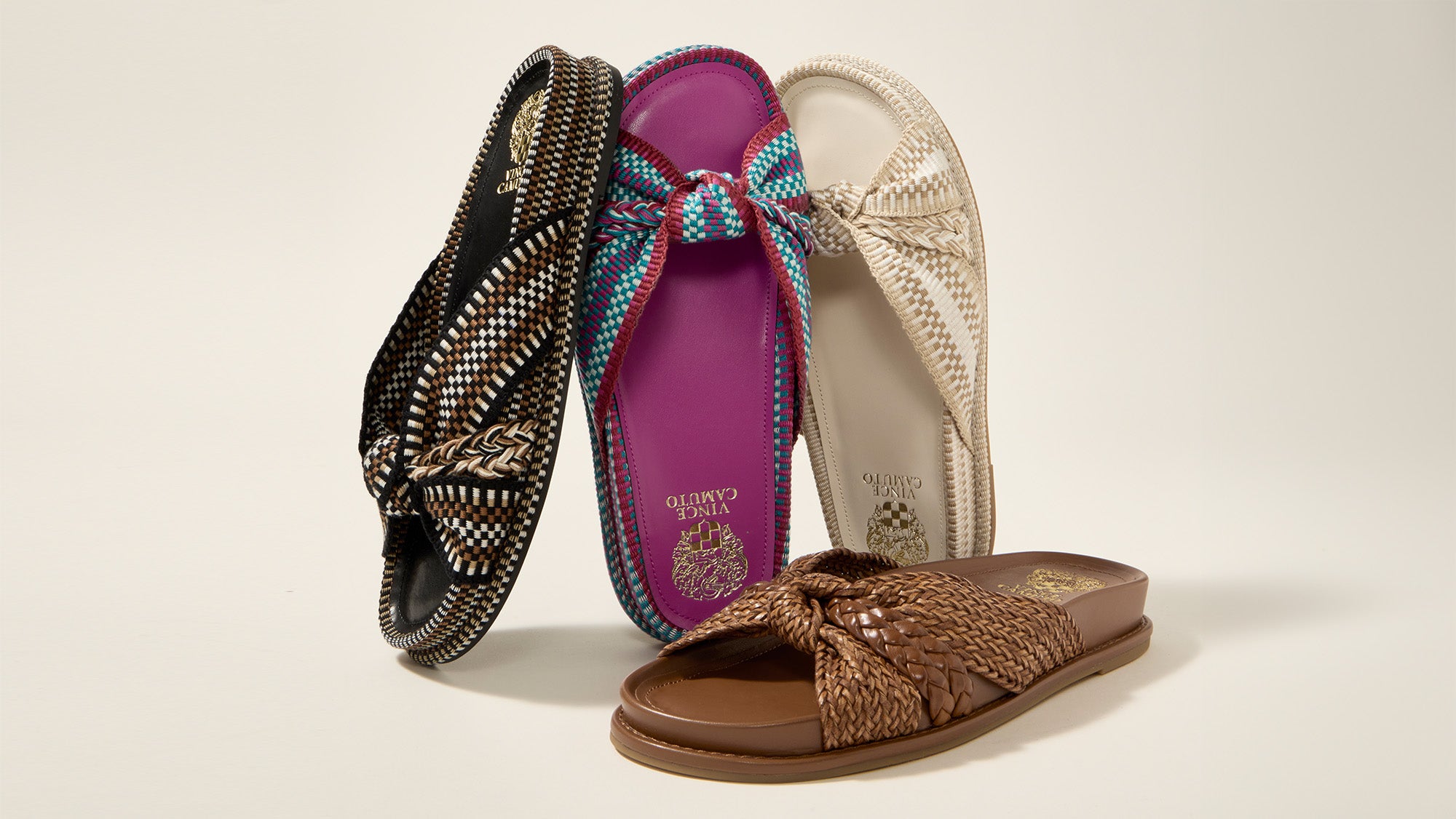 4 multi-colored sandals on gray background