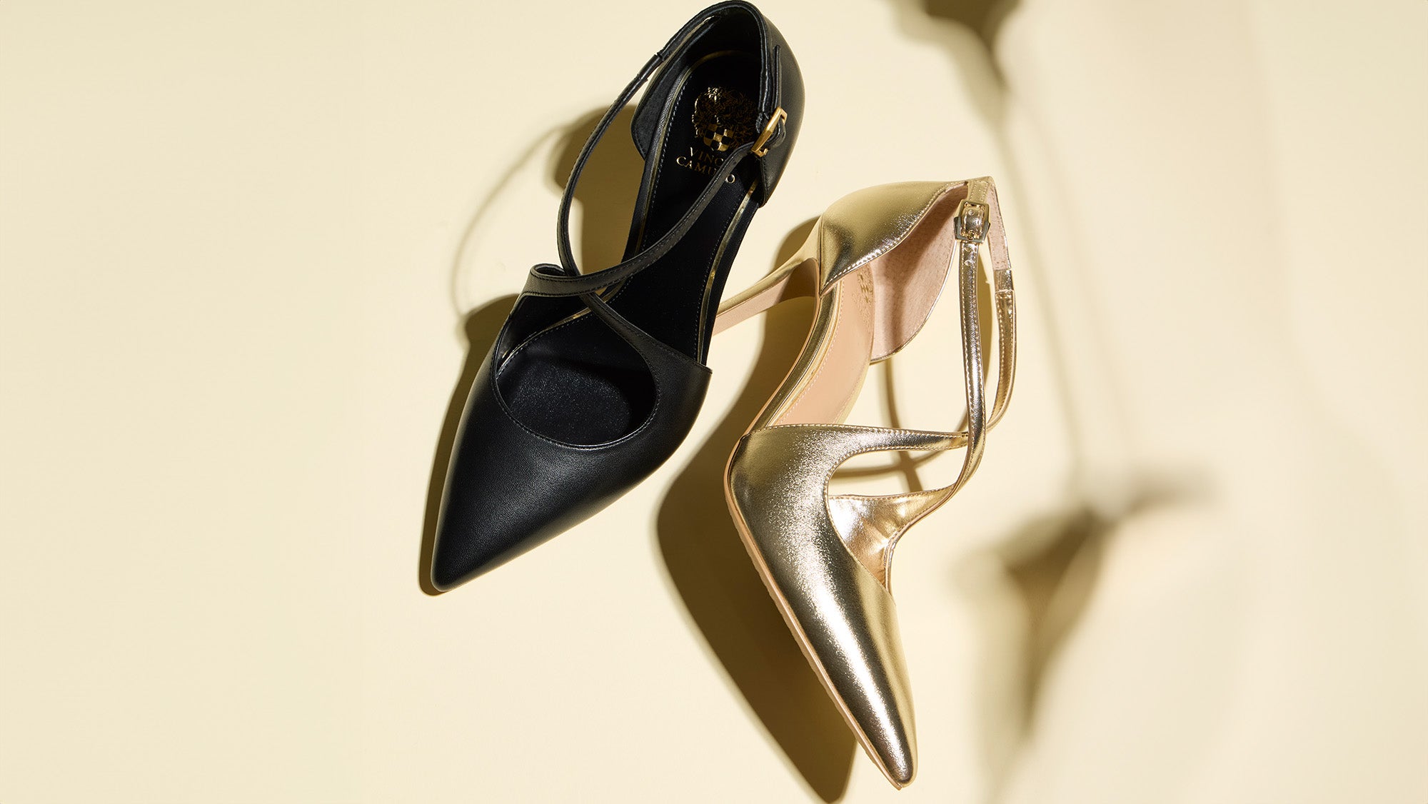 Black and gold high-heeled shoes on a beige background