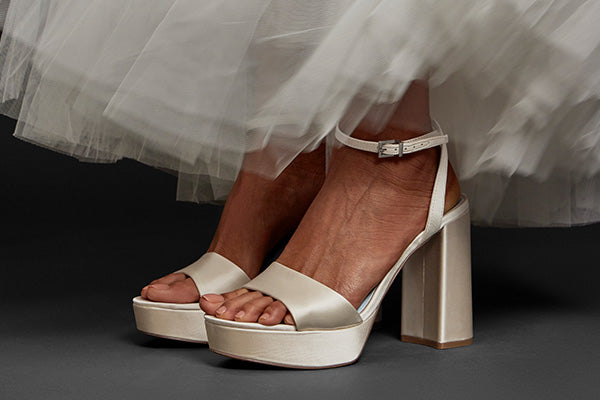 Women sitting in a bridal gown wearing the Pendry Platform Sandal in Milk