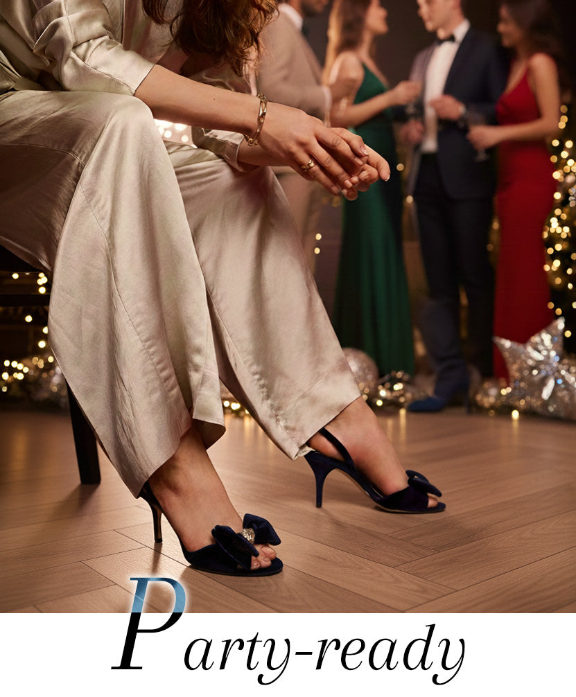 Women seated at a party wearing the Pacyen Sandal in Deep Navy with the text "Party-ready" overlayed