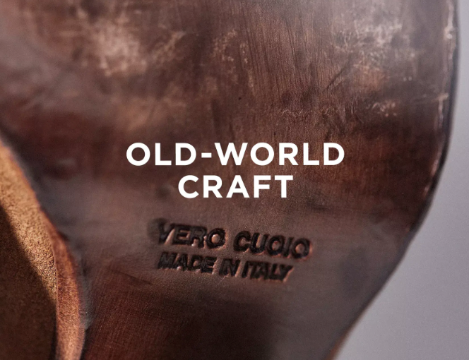Close-up of a leather shoe sole stamped with VERO CUOIO MADE IN ITALY, with the words OLD-WORLD CRAFT overlaid in white text.