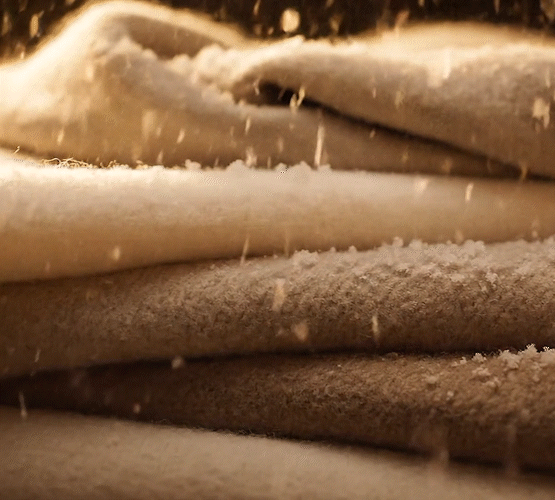 Relaxing video of soft fabric with light snow falling over it