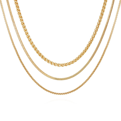 The Vince Camuto Goldtone 3 Piece Mixed Chain Layered Necklace Set showcases twisted, box, and curb chain designs—three gold-tone necklaces in varied styles layered on a white background for an elegant jewelry collection addition.
