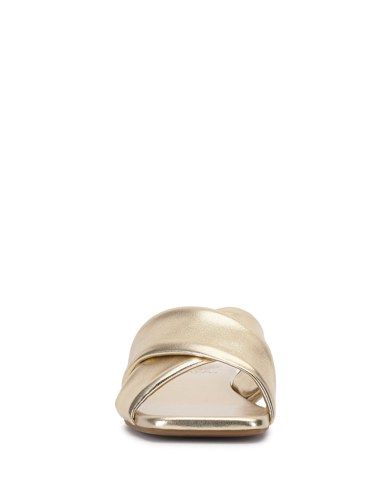 Front view of the Vince Camuto Adisey Cross-Band Sandal in gold, showing crisscross straps and a flat sole for comfort—ideal for daily wear. Pictured on a white background.