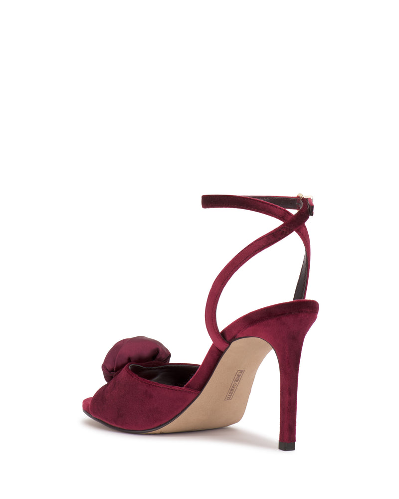 A burgundy Aisven Sandal by Vince Camuto with an ankle strap and large front bow, shown from a back side angle—perfect for evening events against a white background.