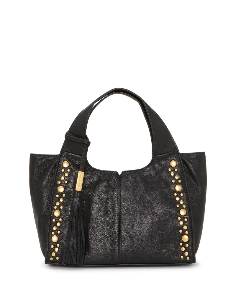 The Aleah Satchel Bag by Vince Camuto is crafted from black leather and features gold studs arranged in vertical rows along both sides. It comes with a short handle, a black tassel accent adorned with a small gold tag, and boasts a slouchy, soft structure. For added versatility, the bag includes a convenient crossbody strap.