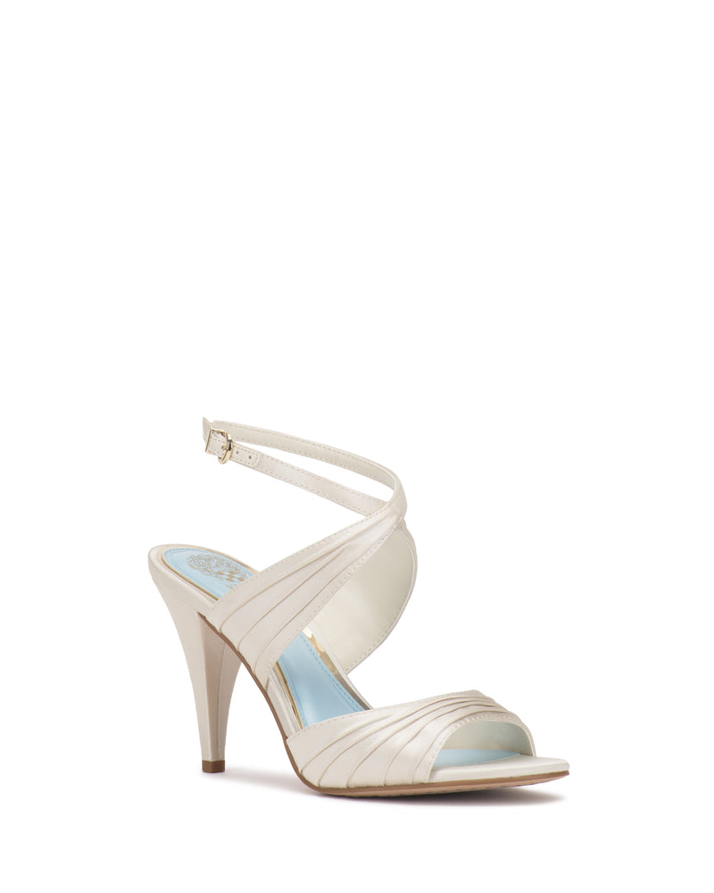 A single Vince Camuto Altnori Sandal in beige with crisscross straps, open toe, and a thin ankle buckle strap is displayed on a white background.