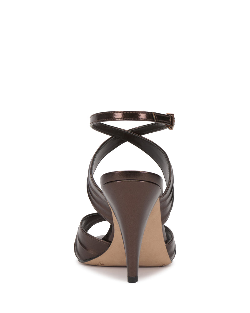 Rear view of the Vince Camuto Altnori Sandal featuring an ankle strap, crisscross straps at the back, a closed heel, and a light beige sole.