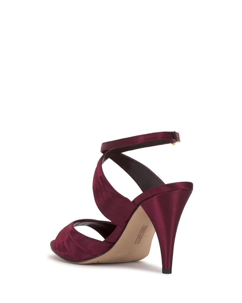 The Altnori Sandal by Vince Camuto features burgundy satin, an ankle strap, open toe, and elegant heel. A back view shows the heel and beige sole on a plain white background.
