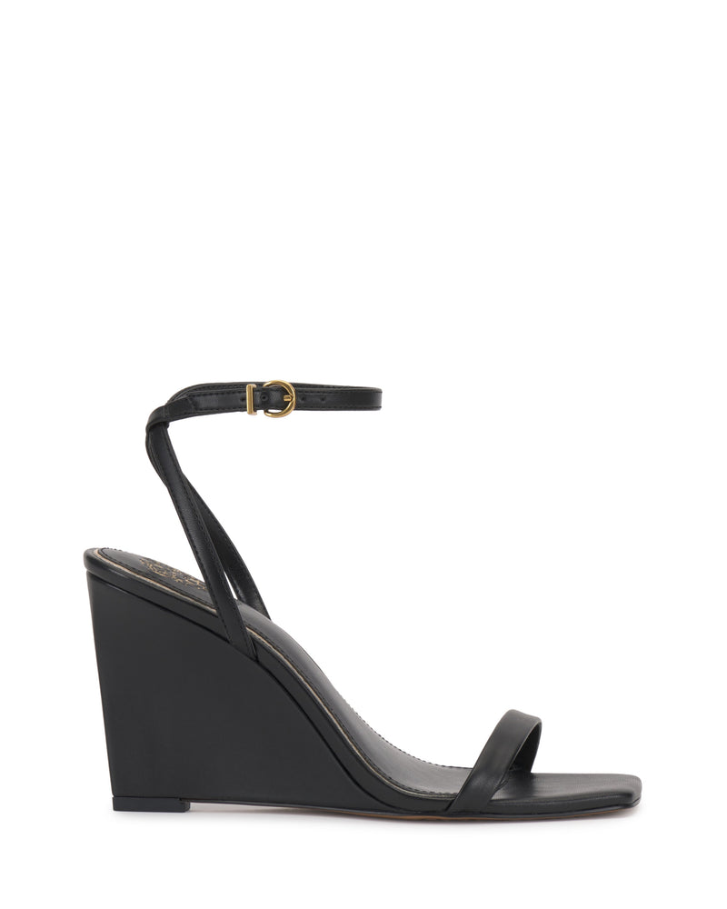 The Vince Camuto Ambee Wedge Sandal features a black, open square toe with a single front strap and ankle strap with gold buckle. Its high solid wedge heel and minimalist design make it ideal for formal occasions.