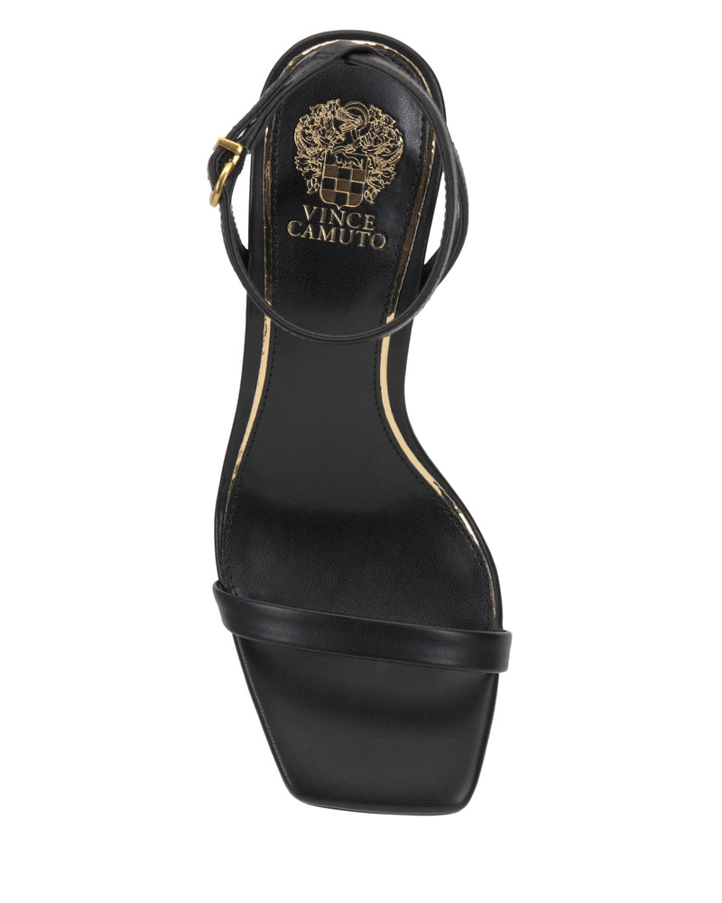 The Vince Camuto Ambee Wedge Sandal is a black, square-toe sandal with a gold insole logo, single toe strap, and ankle buckle—ideal for formal occasions and shown from a top-down view.