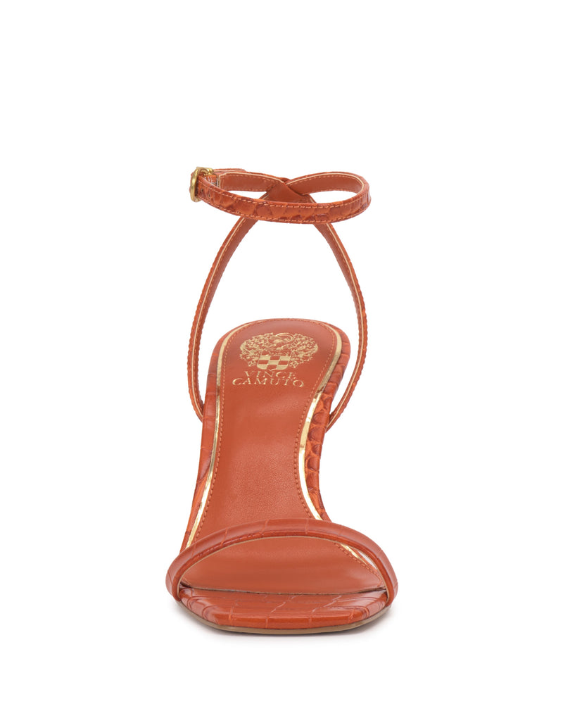 Front view of the Vince Camuto Ambee Wedge Sandal in orange, featuring a thin ankle strap with gold buckle, crocodile texture, square toe, and gold logo on the insole—ideal for formal occasions.