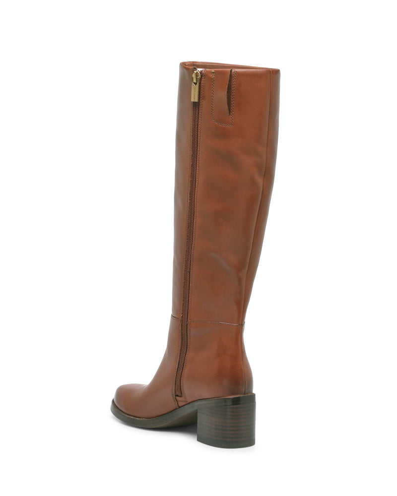 The Ammar Narrow Calf Knee High Boot by Vince Camuto is a brown leather boot featuring a chunky block heel, side zipper, and slightly rounded toe, shown from the side against a white background—a versatile addition to any casual wardrobe.