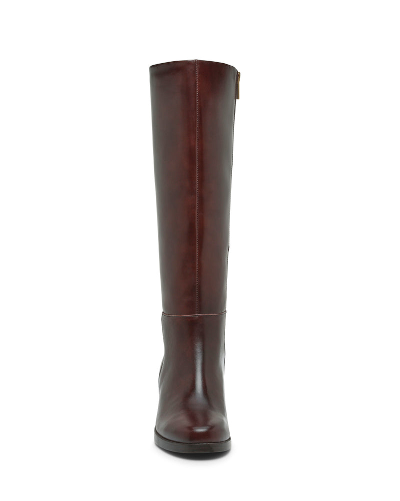 A front view of the Vince Camuto Ammar Wide Calf Knee High Boot—a tall, brown leather riding boot with a rounded toe and flat sole—features a striking knee-high silhouette, displayed against a white background.