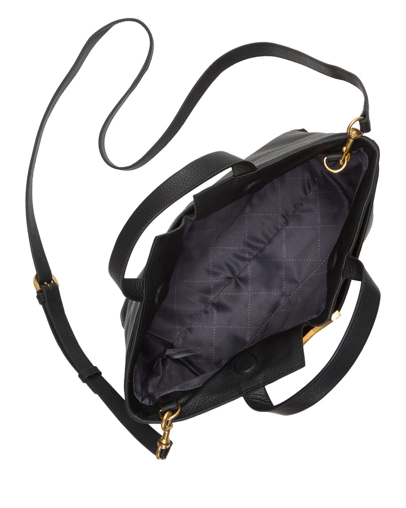 The Vince Camuto April Satchel Bag features black leather, two handles, a long adjustable strap, gold hardware, and a quilted dark grey interior lining visible through its open main compartment.