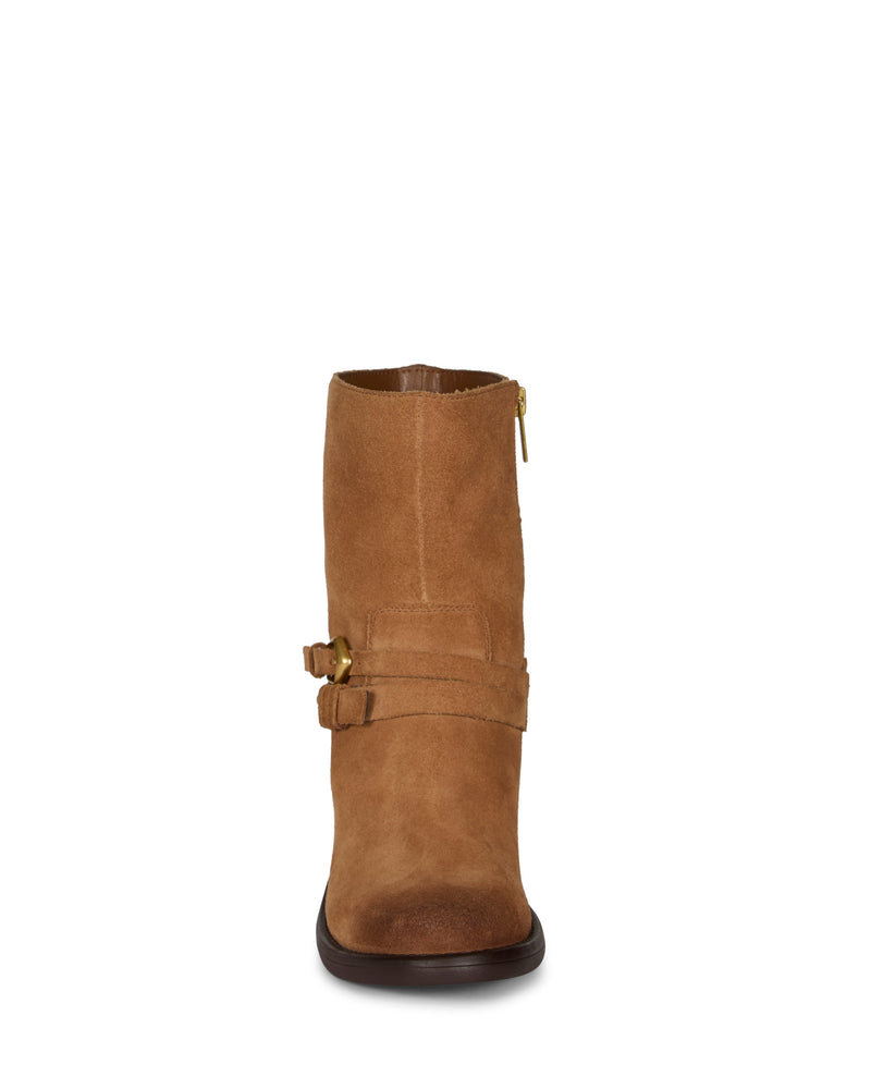 Front view of the Vince Camuto Armia Bootie in brown suede, featuring a gold side zipper and two decorative straps with gold-tone buckles around the lower ankle. This boot showcases a rounded toe, a block heel, and subtle harness accents for added style.