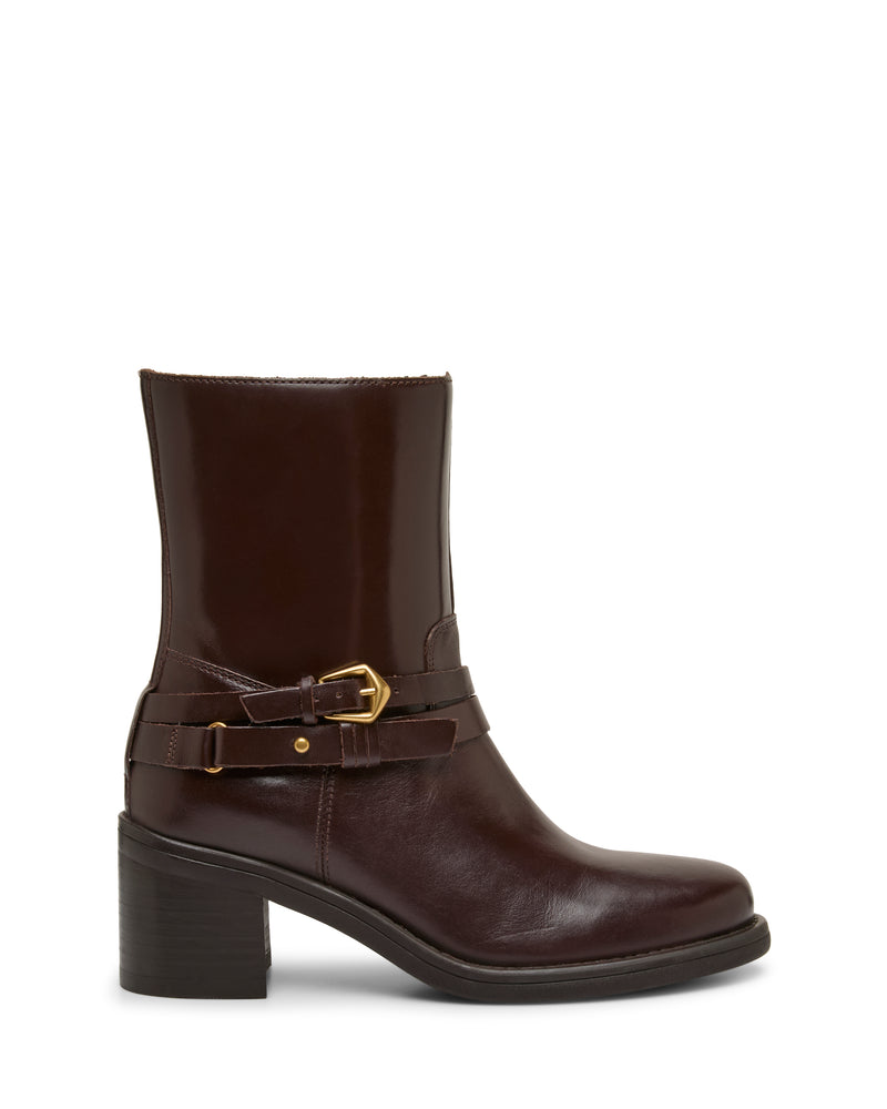 The Armia Bootie by Vince Camuto is a dark brown leather ankle bootie with a mid-height block heel, featuring a gold buckle harness detail and a decorative strap around the ankle, shown in side profile on a white background.