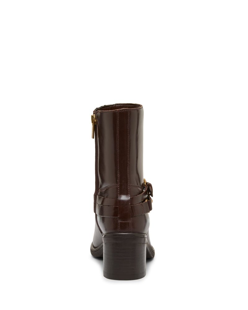 The Armia Bootie by Vince Camuto is a dark brown, mid-calf leather bootie featuring a block heel, side zipper, and decorative buckle harness detail, displayed from the back against a white background.