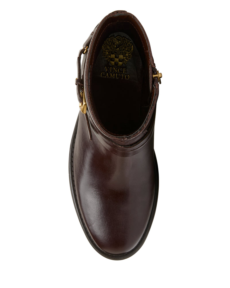 Top view of the Vince Camuto Armia Bootie in dark brown leather, showcasing a gold buckle harness and the Vince Camuto logo visible inside.