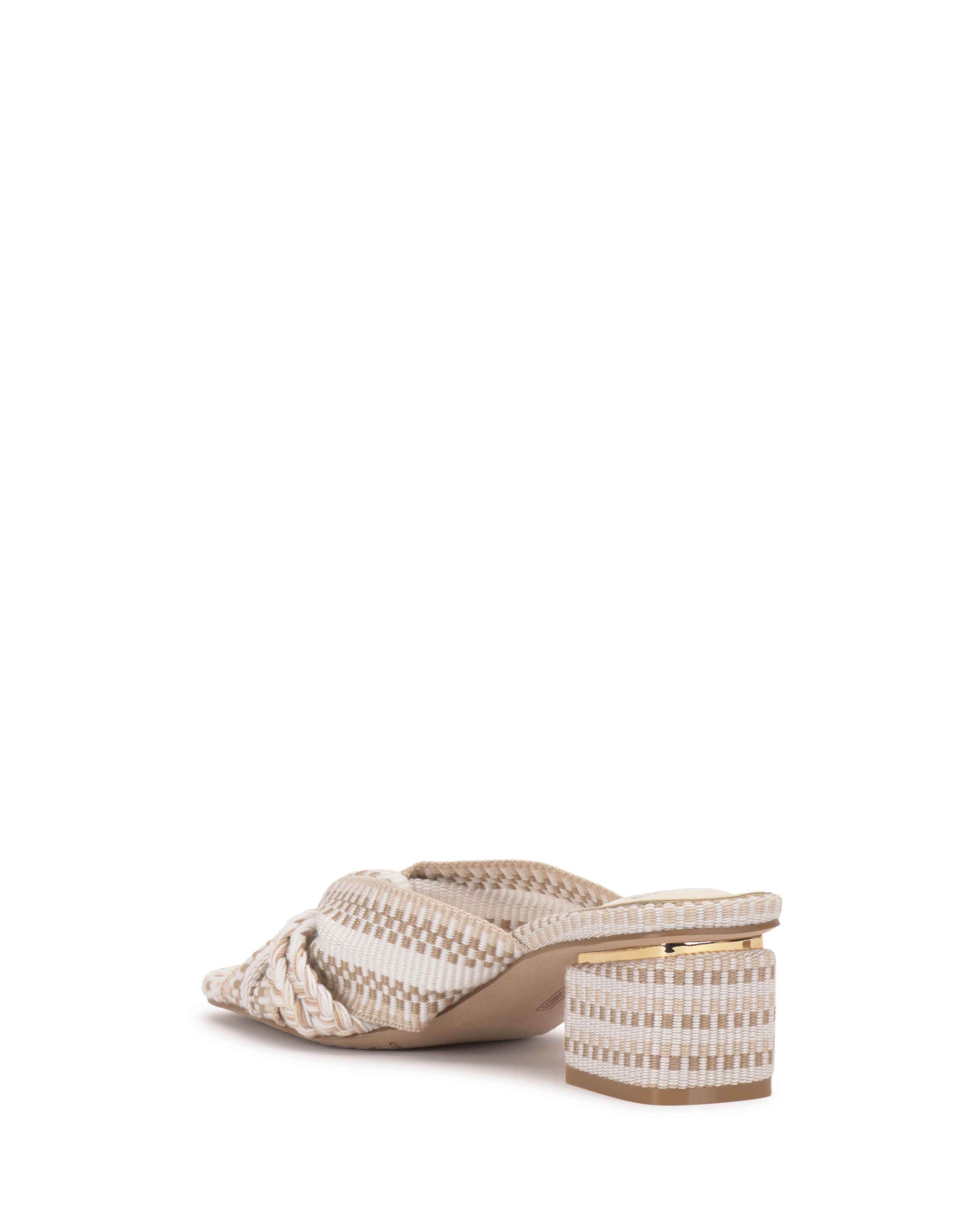 The Vince Camuto Atemly Knotted Sandal is a beige bohemian-style woven sandal with a low block heel, open back, and braided strap design, pictured against a white background.