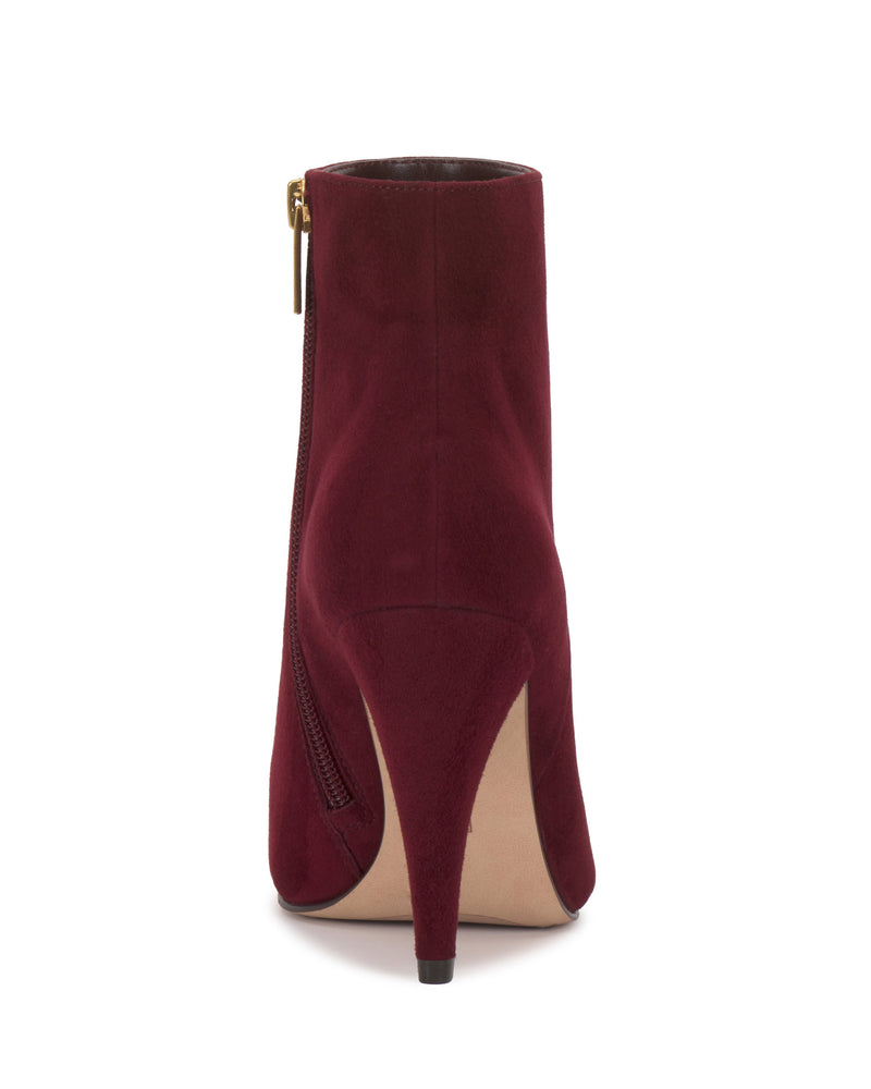 The Attiza Bootie by Vince Camuto is a burgundy suede ankle bootie with a pointed toe, stiletto heel, and side zipper, shown from the back against a white background.