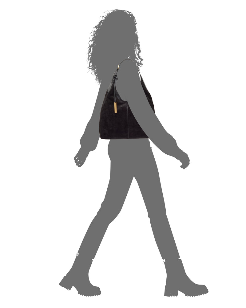 A sophisticated black Vince Camuto Aylla Hobo Bag with gold hardware worn over the shoulder of a person in silhouette.