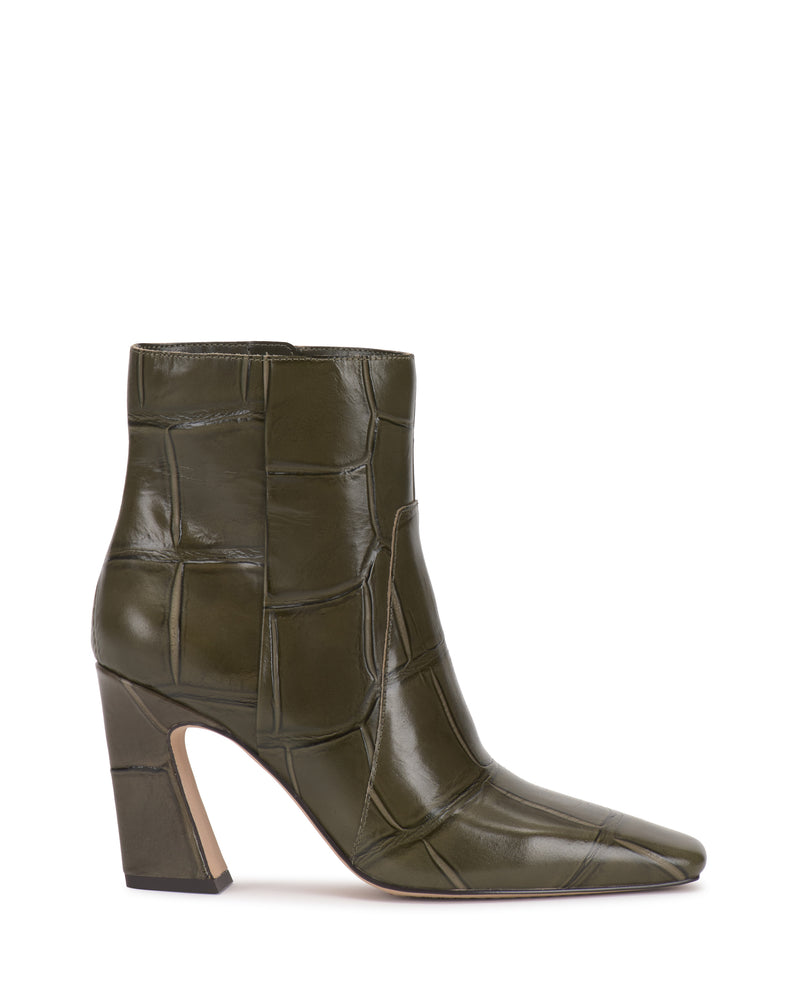 The Bayla Bootie by Vince Camuto is an olive green leather ankle boot featuring a square toe, block heel, and stitched patchwork design. With a polished finish and convenient side zipper, this stylish bootie adds modern flair to any outfit.