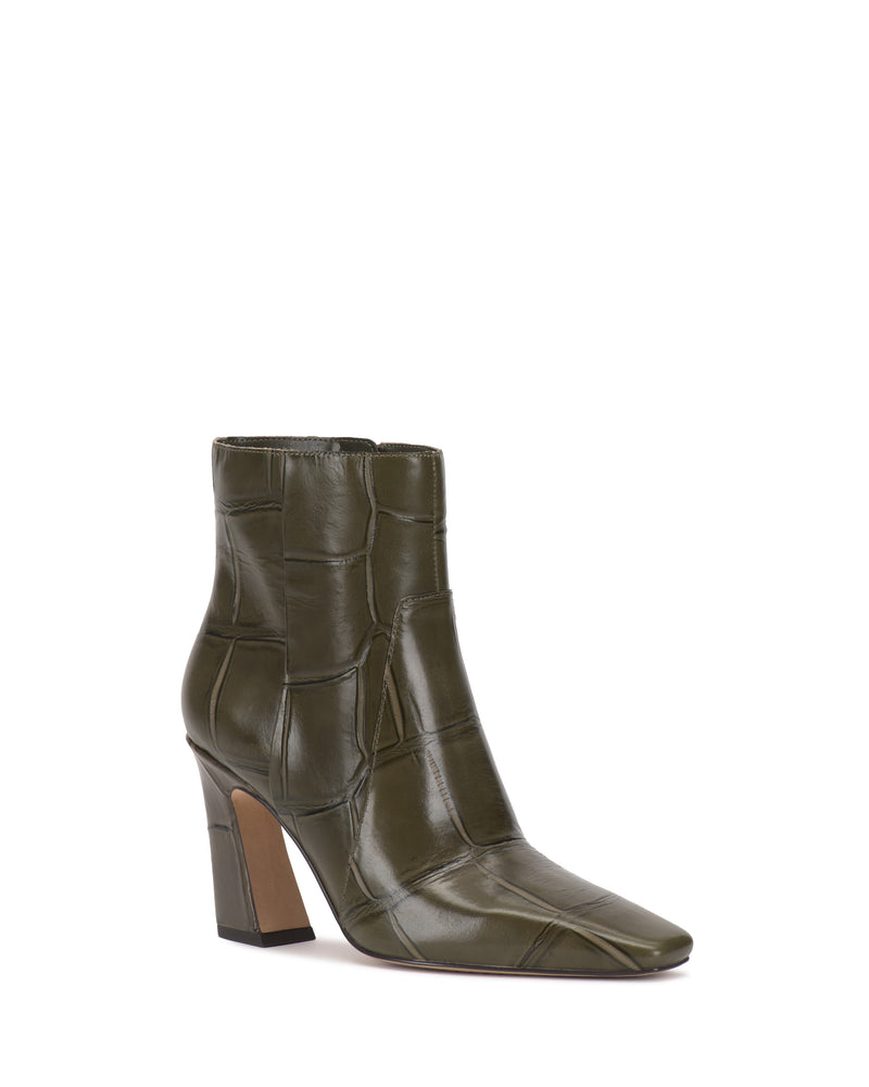 The Vince Camuto Bayla Bootie is an olive green ankle-height boot with a square toe and block heel, featuring a crocodile-patterned texture, high-shine leather look, and distinctive side seam detailing.