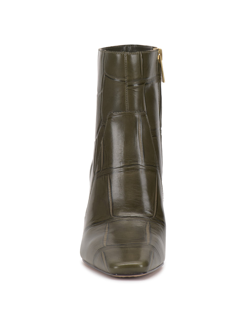Front view of the shiny, olive green Vince Camuto Bayla Bootie with a crocodile texture and a side zipper, displayed against a plain white background. This stylish bootie features an ankle-height silhouette for modern flair.