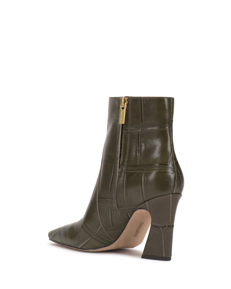 The olive green Vince Camuto Bayla Bootie features a high heel, pointed toe, and geometric textured pattern with a gold side zipper. This ankle-height bootie is showcased from an angled rear view on a white background, offering effortless style.