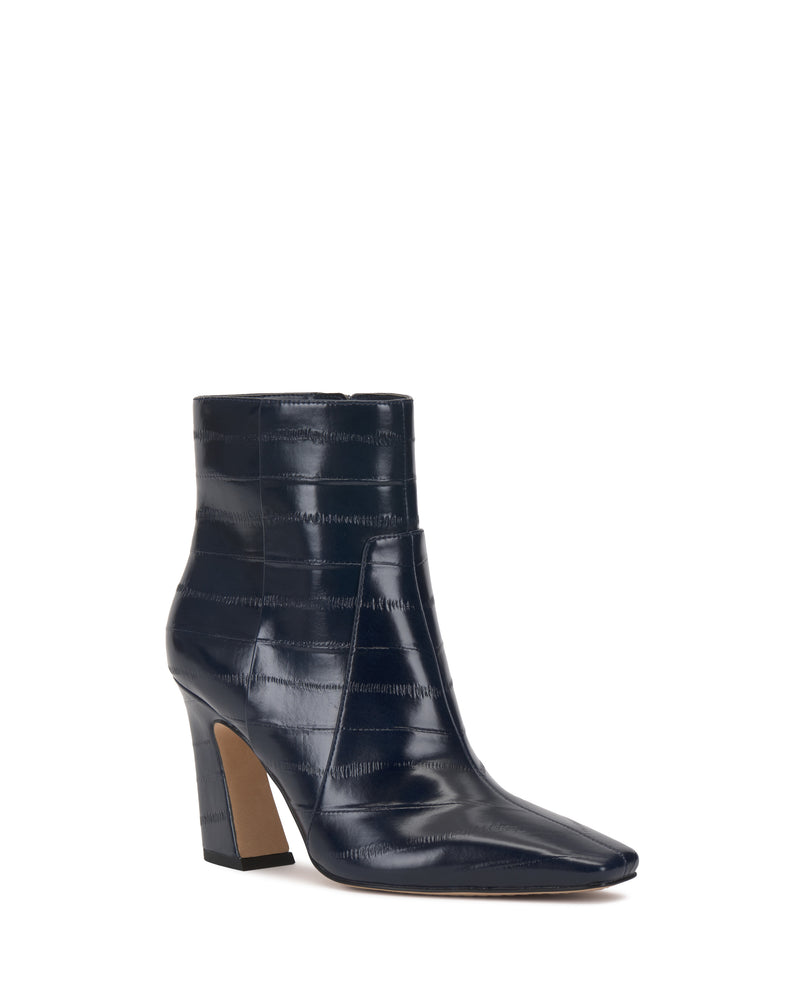 The Vince Camuto Bayla Bootie features a dark blue hue, high heel, slightly pointed toe, and a textured crocodile-patterned finish—an effortlessly stylish choice for any look.