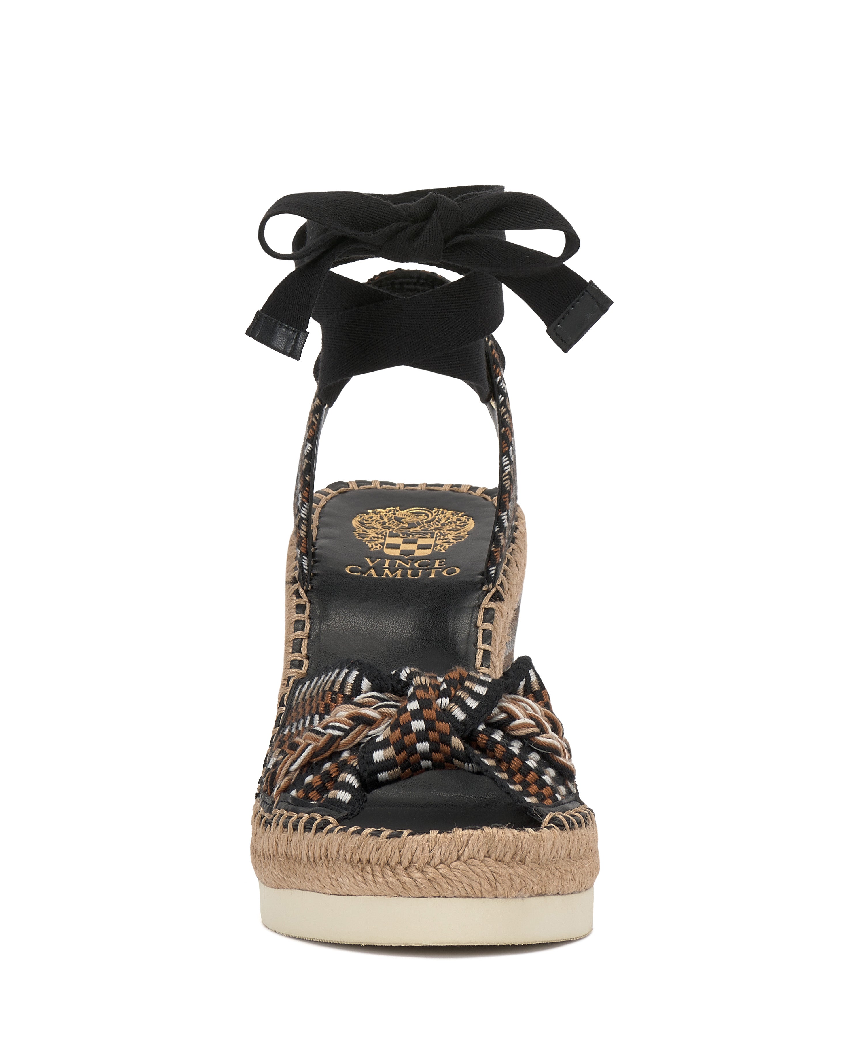 Front view of the Vince Camuto Bealie Wedge Sandal, a bohemian platform espadrille with woven multicolor strap, jute-wrapped sole, black ankle ties, and black footbed featuring a gold lion and Camuto branding.