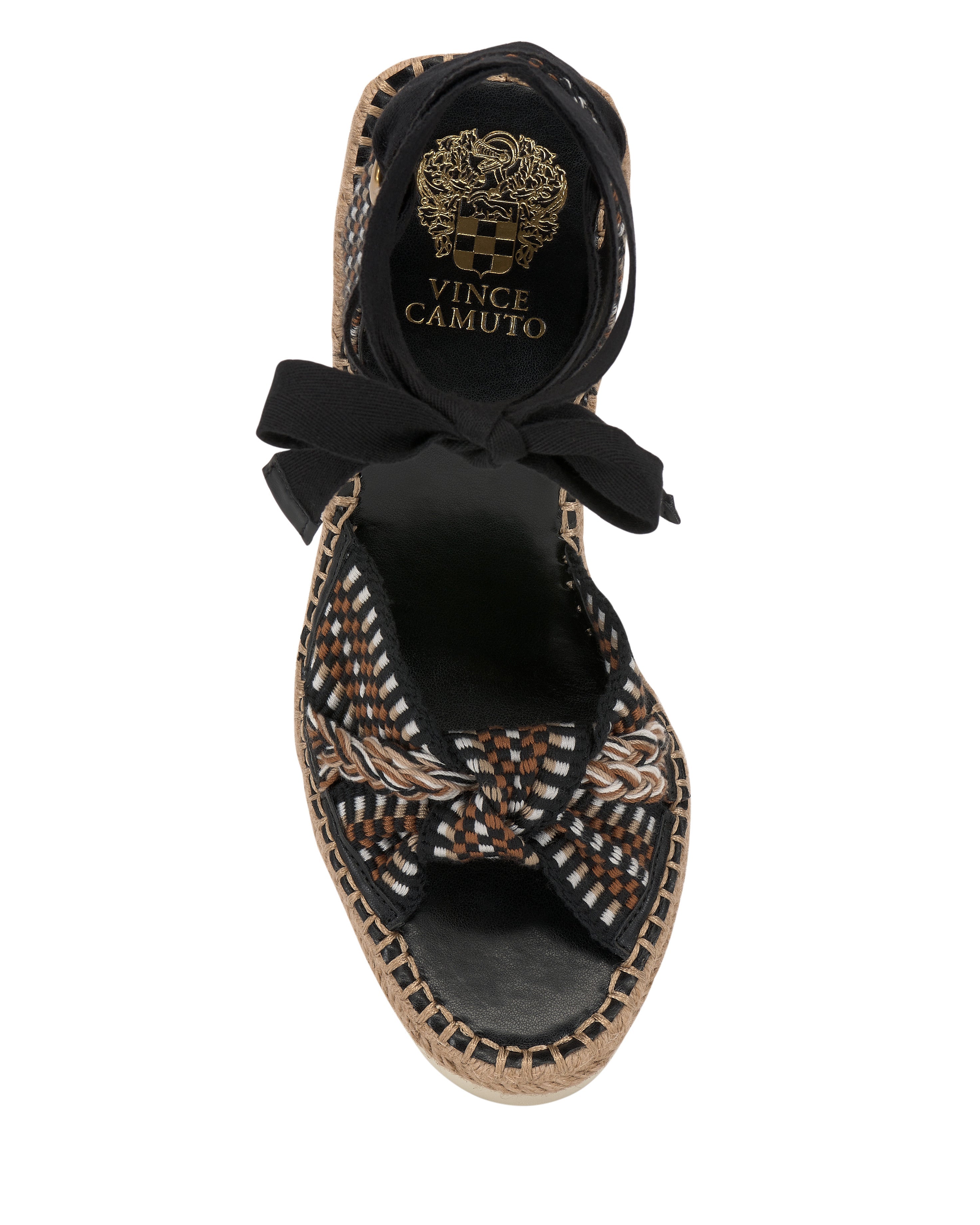 Top view of the Vince Camuto Bealie Wedge Sandal, featuring a woven multicolor pattern, knotted front strap, black insole and ankle tie. The gold brand logo on the heel adds a chic bohemian touch.