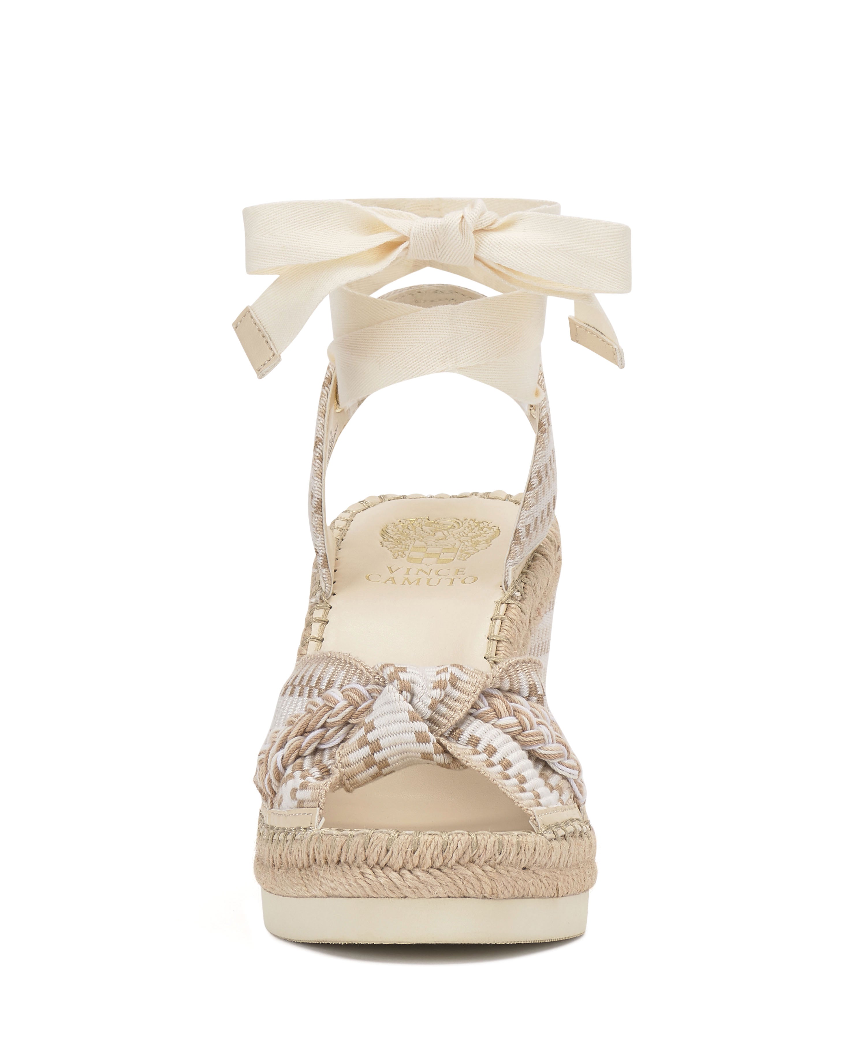 Front view of the Bealie Wedge Sandal by Vince Camuto in beige and cream, featuring braided straps, a textured platform sole, and a cream ankle tie bow closure.
