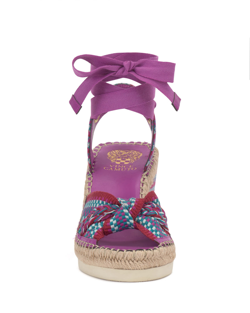 Front view of the Vince Camuto Bealie Wedge Sandal featuring a woven multicolor toe strap, purple insole, ankle tie closure, and a jute-detailed espadrille wedge heel for a playful, bohemian look.