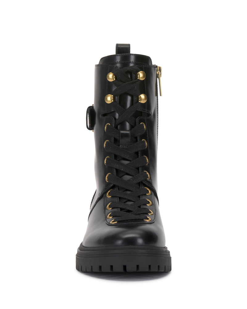 Front view of the Becinda Moto Bootie by Vince Camuto, featuring black leather, black laces, gold eyelets, a side zipper, and a thick treaded sole.