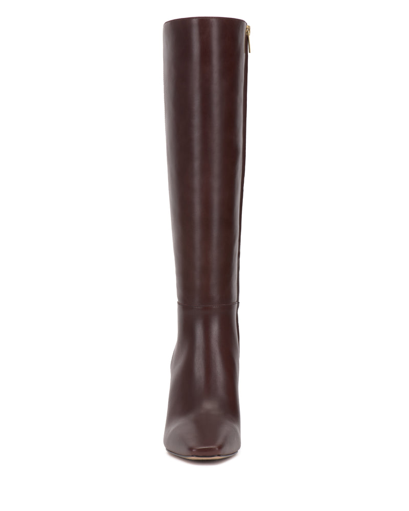 A single Bennidy Wide Calf Knee High Boot by Vince Camuto, crafted in dark brown leather, stands upright on a white background and is viewed directly from the front—a true wardrobe staple.