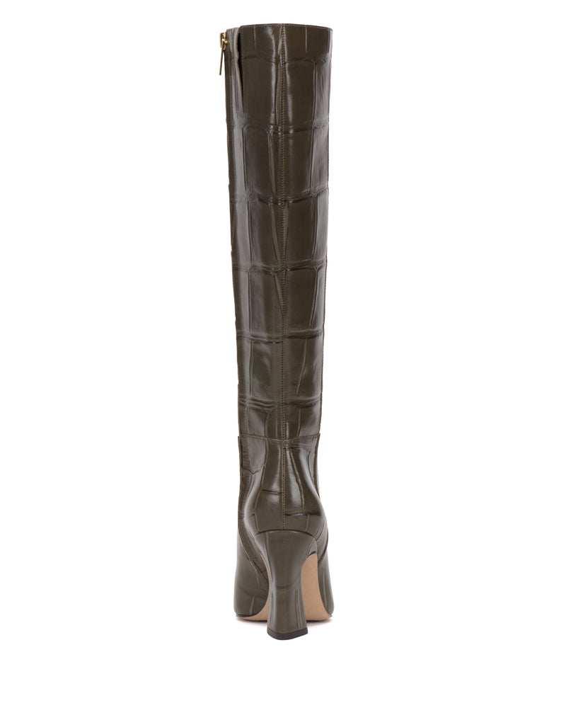 A tall, dark green, crocodile-embossed leather Bennidy Wide Calf Knee High Boot by Vince Camuto, shown from the back. This boot features a block heel, a zipper at the top, and a light-colored sole—making it a true staple for any stylish wardrobe.