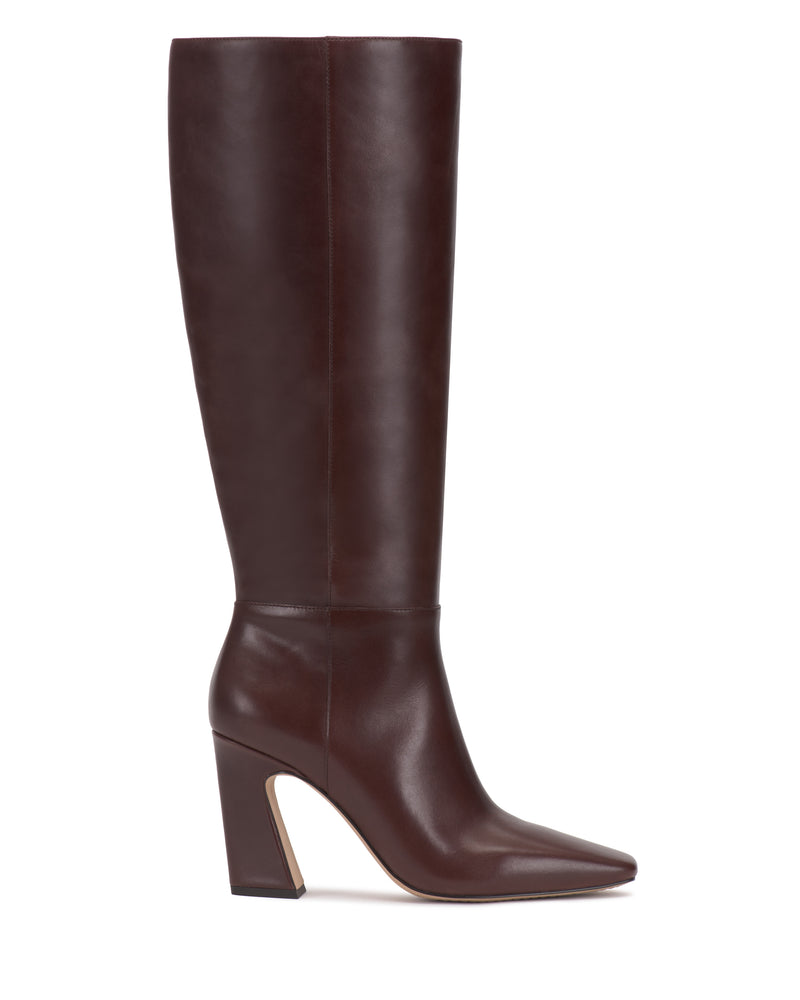 A side-profile view of the Vince Camuto Bennidy Knee High Boot is displayed against a plain white background, showcasing its tall, dark brown leather construction, pointed toe, and stylish block heel—an essential wardrobe staple.