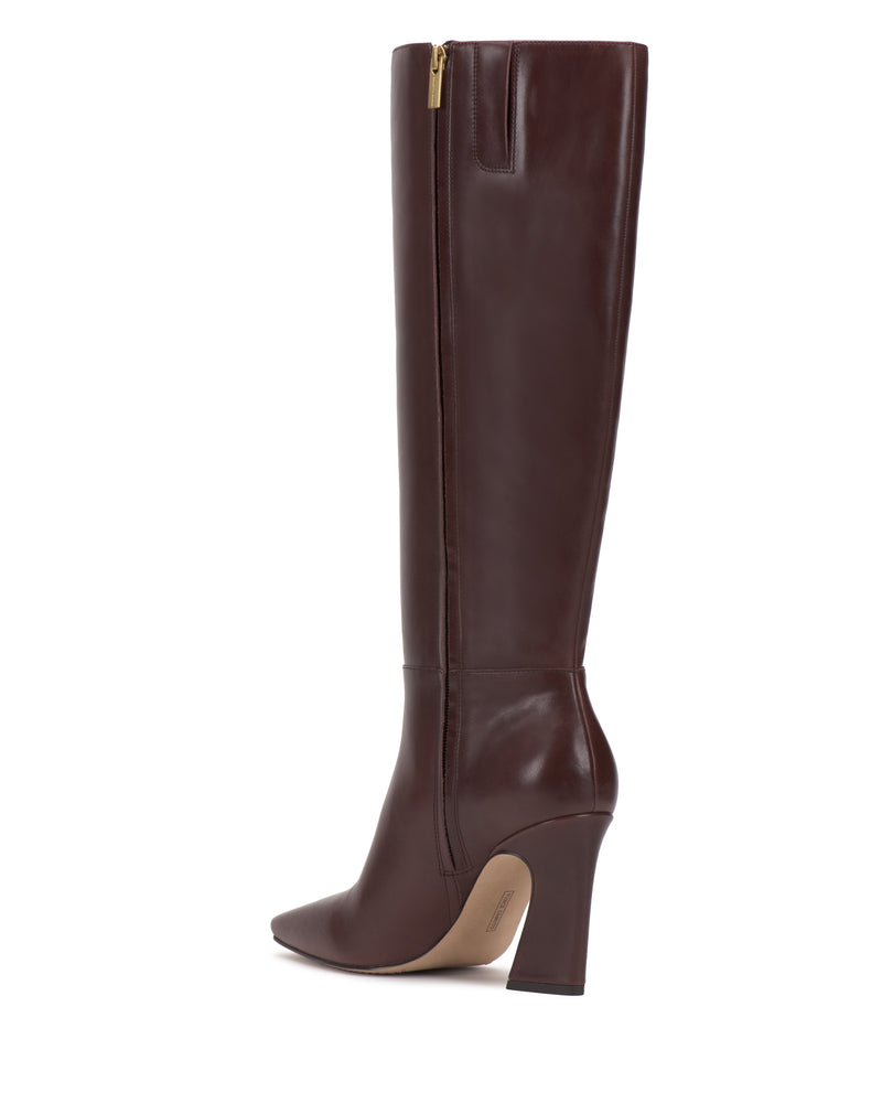 A single Bennidy Knee High Boot by Vince Camuto in tall, dark brown leather with a pointed toe, block heel, and side zipper is shown in profile against a white background—a true wardrobe staple.