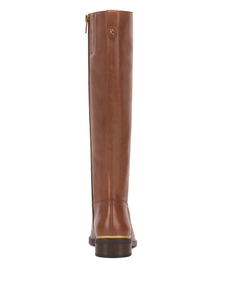 The Vince Camuto Bercla Extra Wide Calf Knee High Riding Boot is shown from the back in brown leather with a zipper up the shaft, low stacked heel, and subtle western style, set against a white background.
