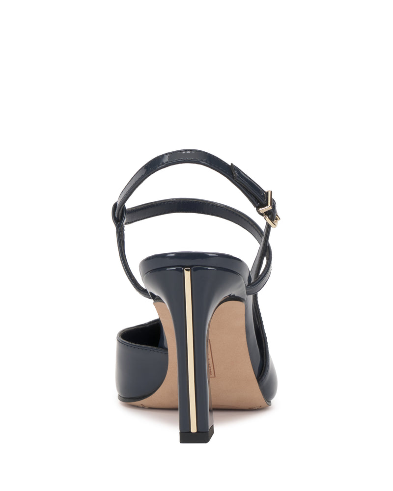 A back view of the Vince Camuto Bevarin Pump in navy blue showcases its high heel design, complete with a gold-accented heel and an ankle strap featuring a gold buckle. The shoe also includes a beige sole and a closed back.