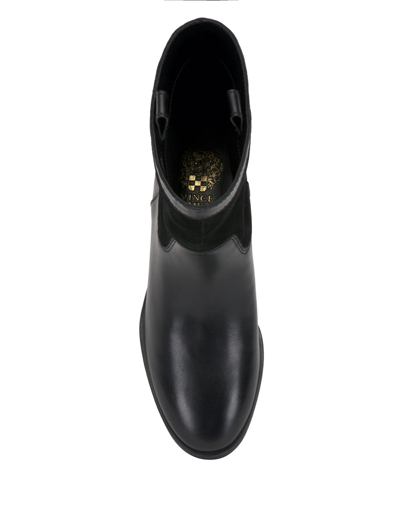 Top view of a single Bezzley Bootie by Vince Camuto in black leather, featuring a slightly rounded toe and a gold Vince Camuto logo on the insole, photographed against a white background.