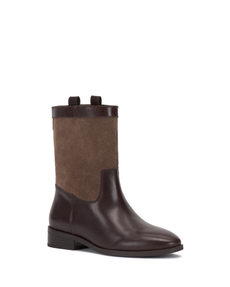 The Vince Camuto Bezzley Bootie features a brown, mid-calf design with a smooth leather lower, suede upper section, low heel, rounded toe, and convenient pull tabs at the top.